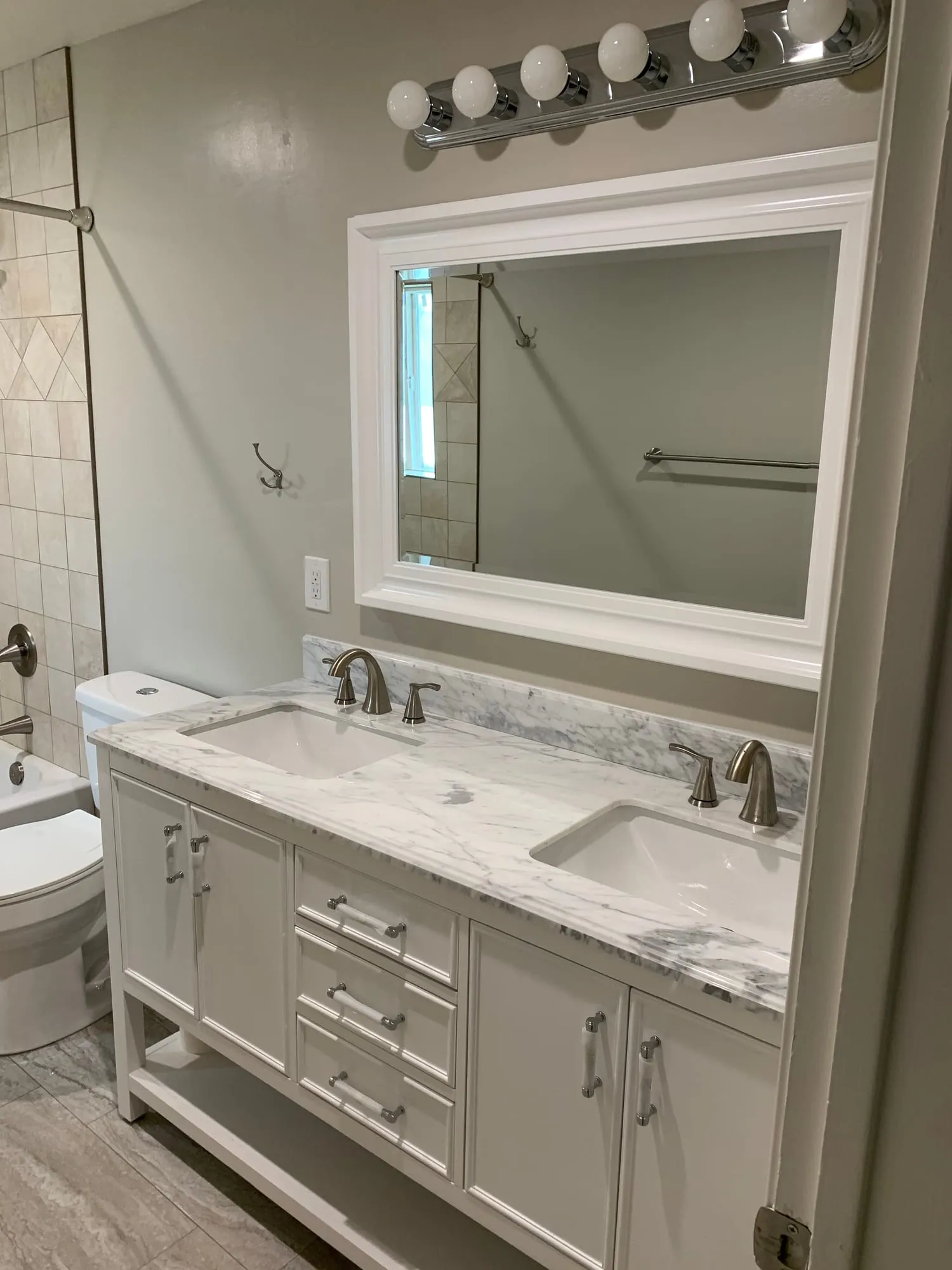 Pebble-Floor Shower & Double Vanities by PrimeSpec Construction — photo 4 of 5