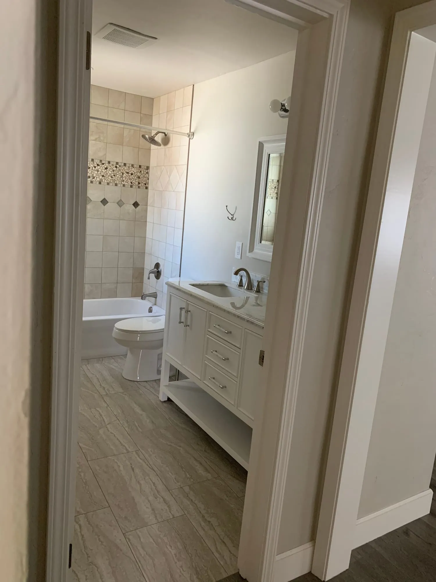 Pebble-Floor Shower & Double Vanities by PrimeSpec Construction — photo 5 of 5