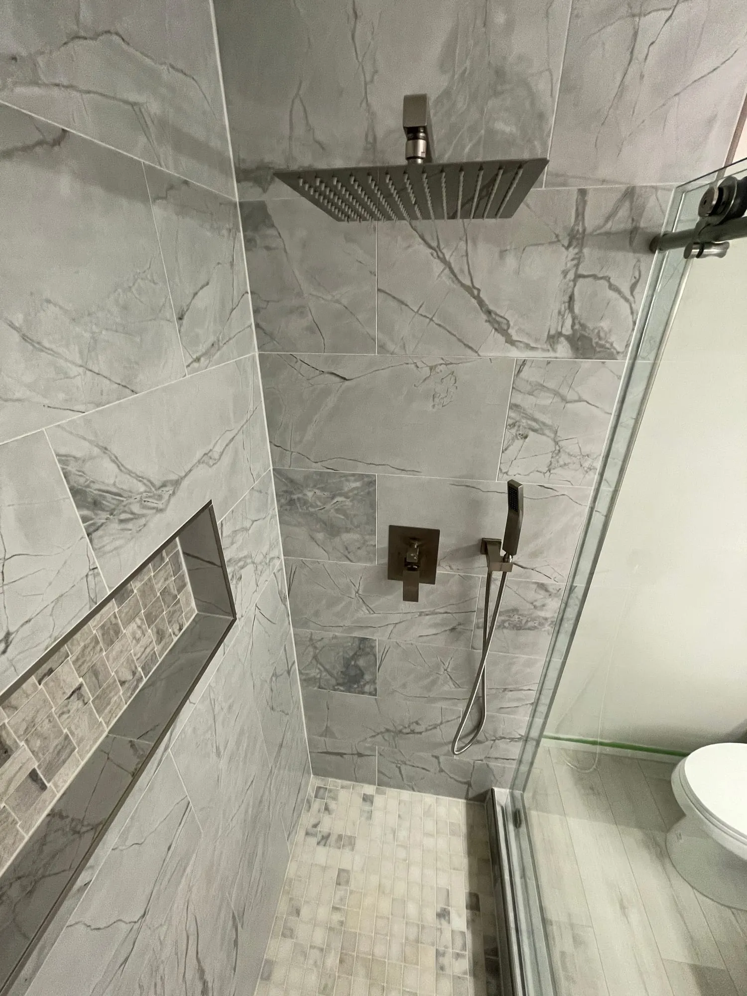 Marble-Look Shower with Mosaic Niche by PrimeSpec Construction — photo 2 of 2