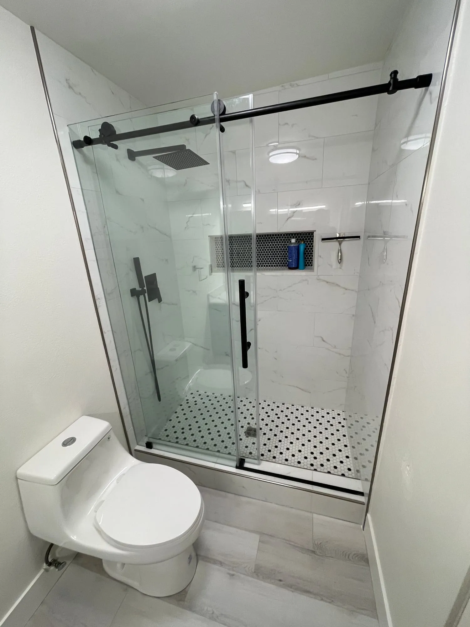Frameless Shower with Matte Black Fixtures by PrimeSpec Construction — photo 2 of 3