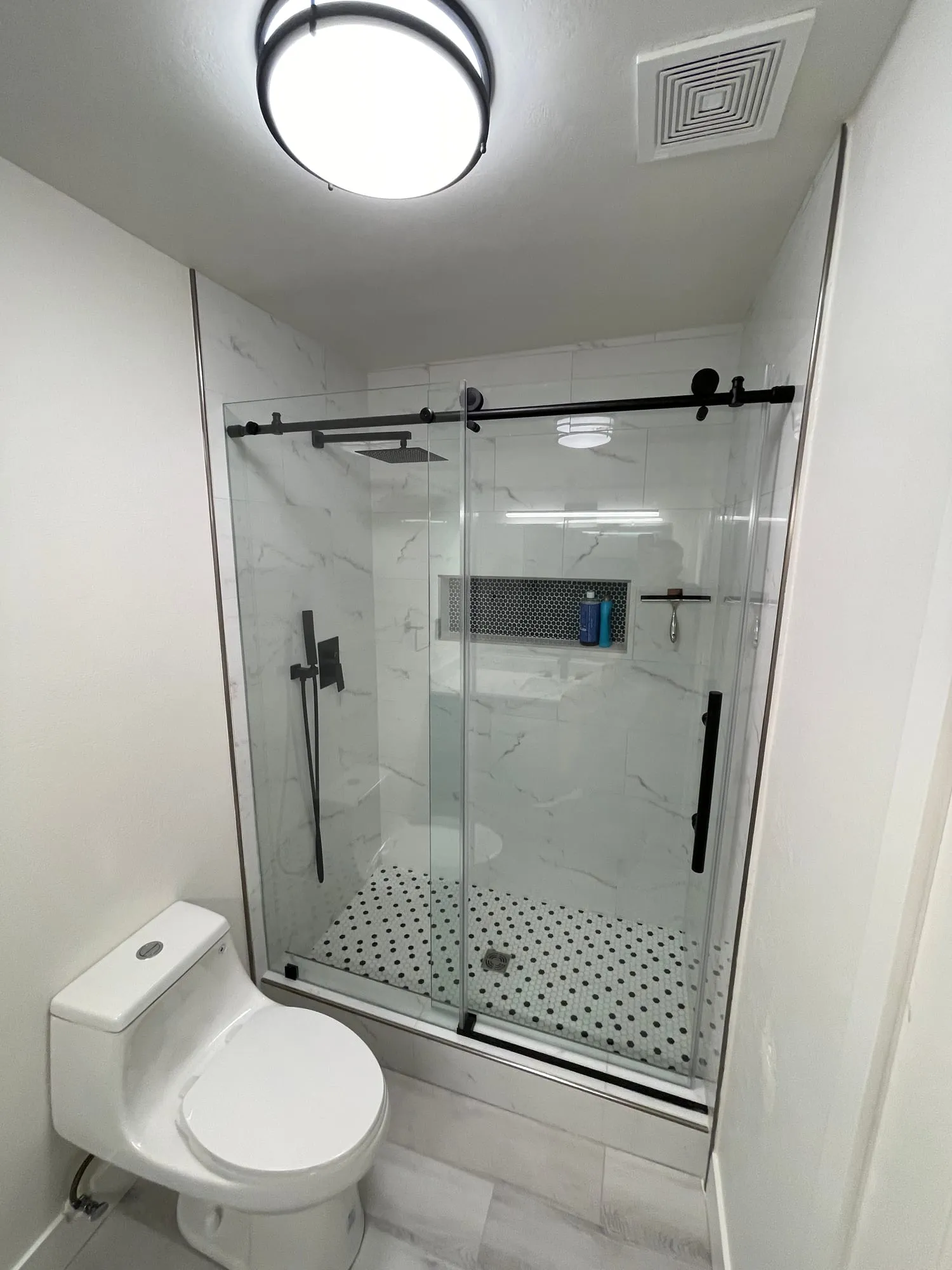 Frameless Shower with Matte Black Fixtures by PrimeSpec Construction — photo 1 of 3