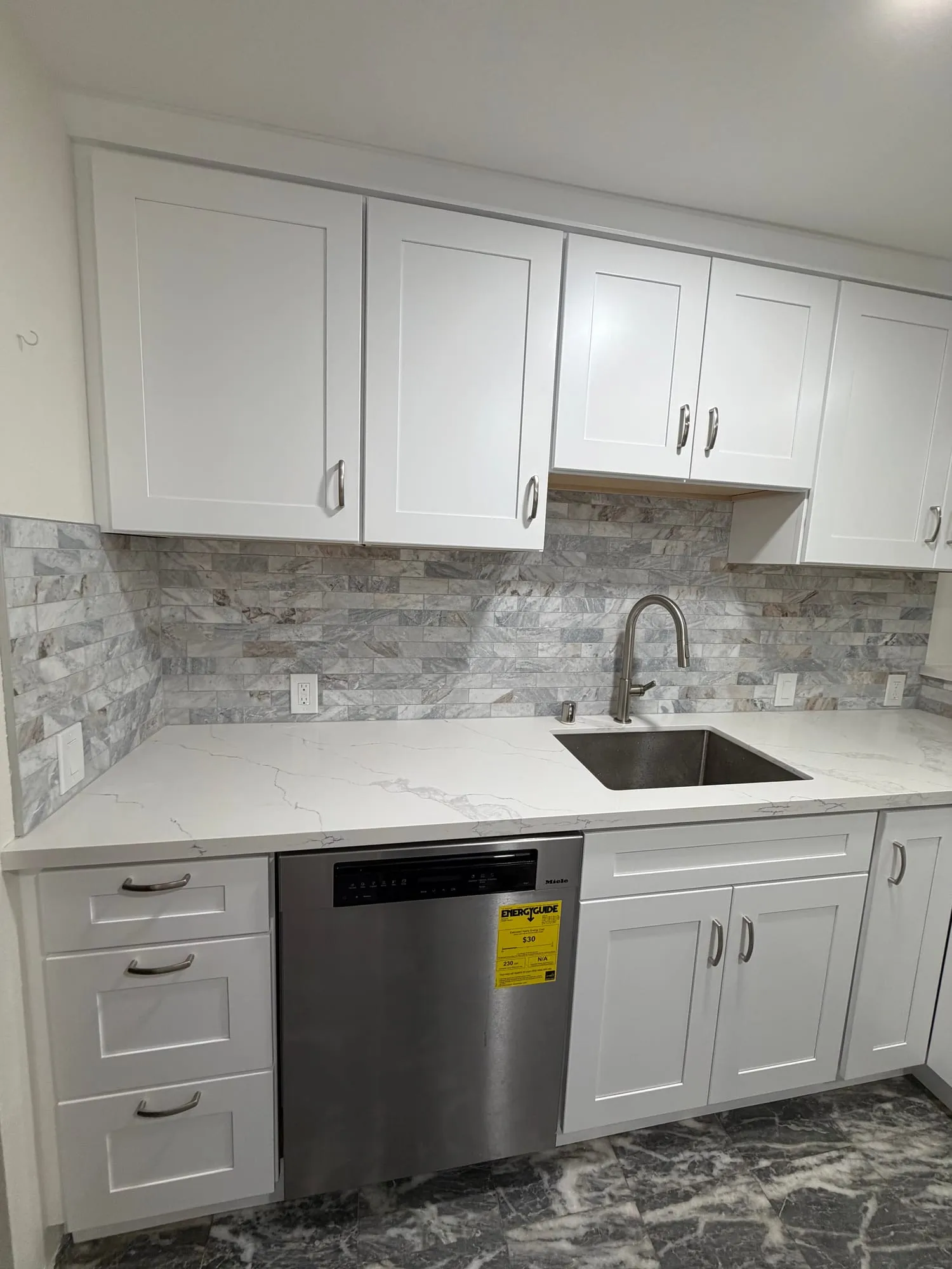 White Kitchen with Stacked-Stone Backsplash by PrimeSpec Construction — photo 2 of 2