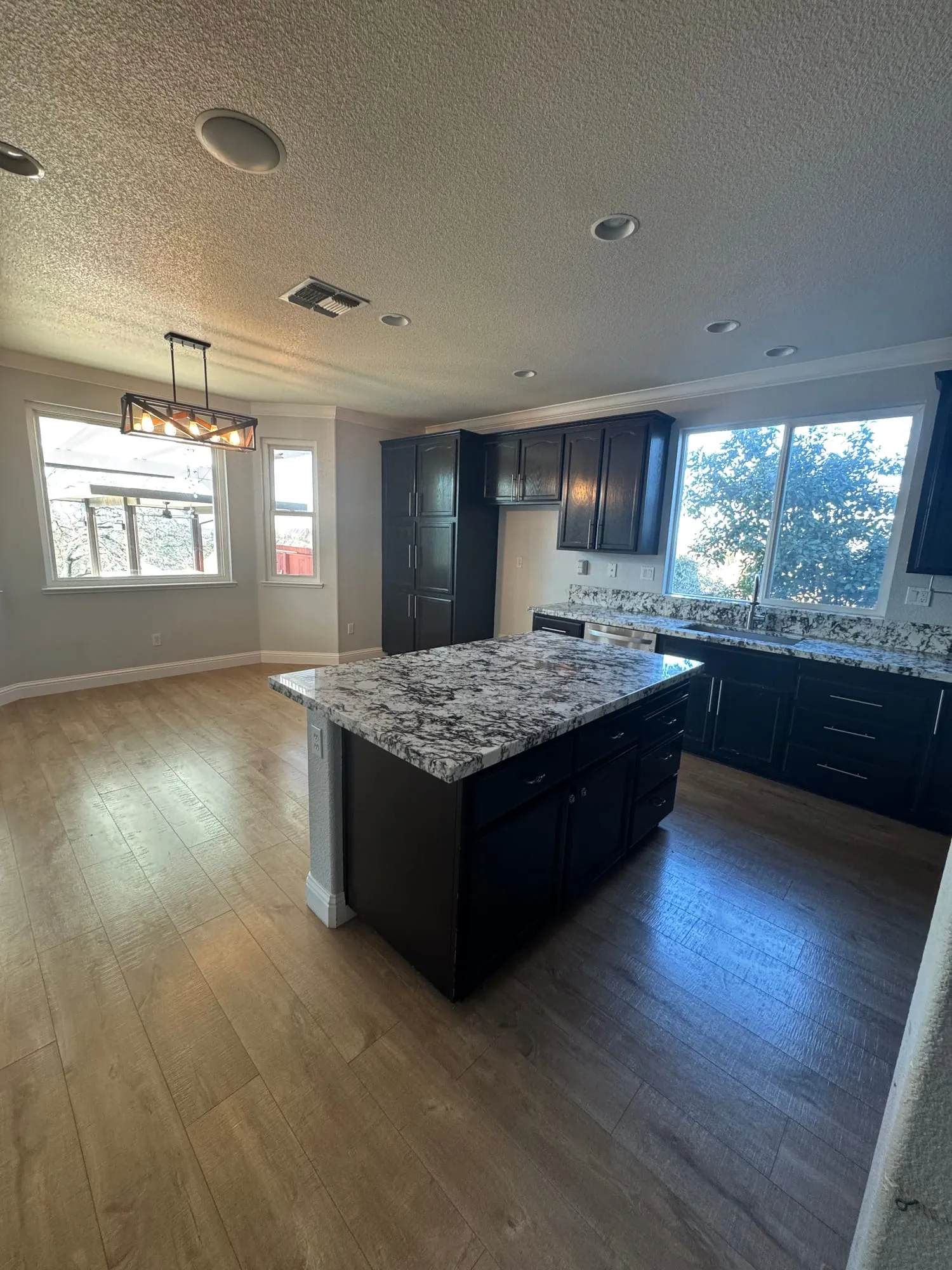 Espresso Cabinet Kitchen with Granite Island by PrimeSpec Construction — photo 1 of 2